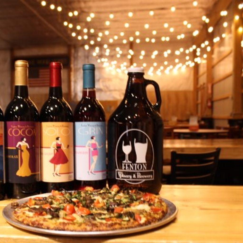 Bottles of wine and beer with a pizza