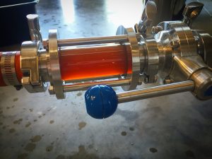 brewery system looking glass to view beer as it transfer from one vessel to another